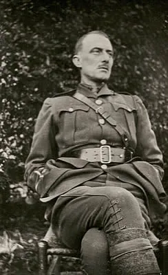 Edward Thomas seated, wearing military uniform.